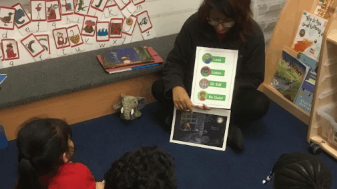 Teacher showing chart to NELI pupils